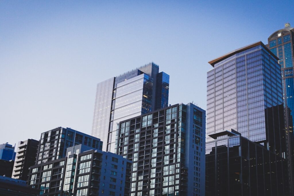 white and blue glass walled high rise building